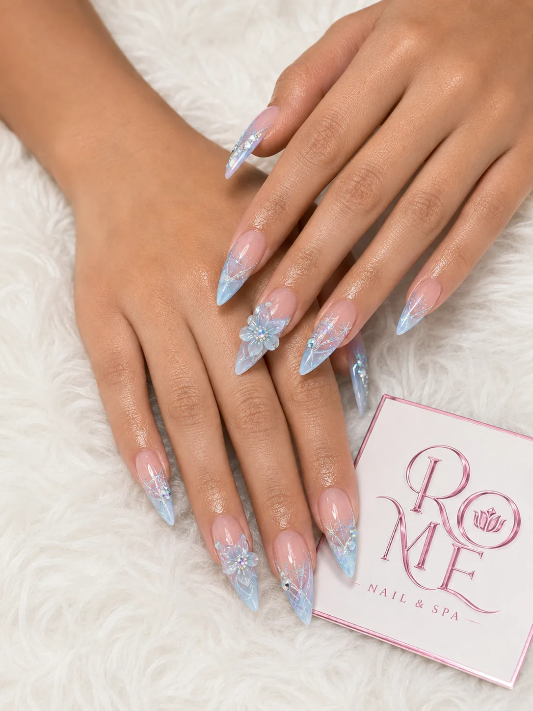 Glossy black French almond nails with silver accents by Rome Nails Spa